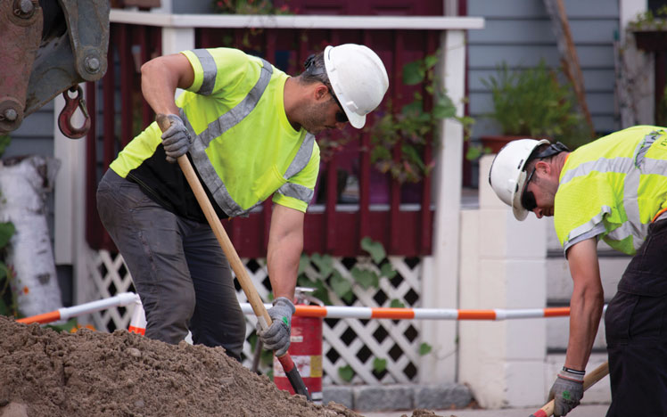 Workers digging with shovels